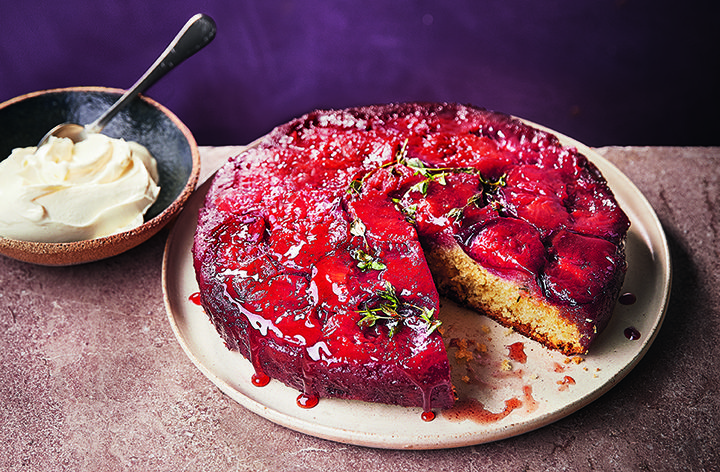 Plum upside down cake, shown with a slice taken out
