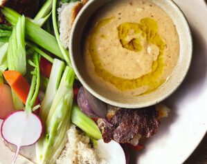 A bowl of bagna cauda tip with crudités