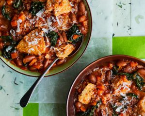 Two bowls of ribollita, Tuscan bean soup, topped with grated parmesan