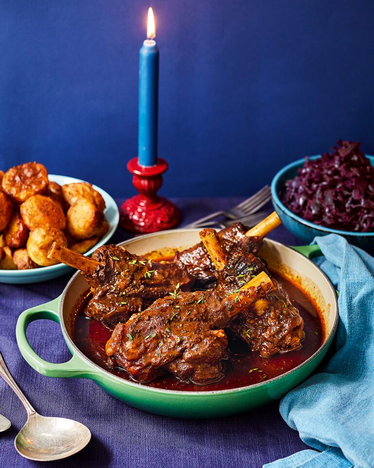 Curried lamb shanks with roast potatoes and red cabbage